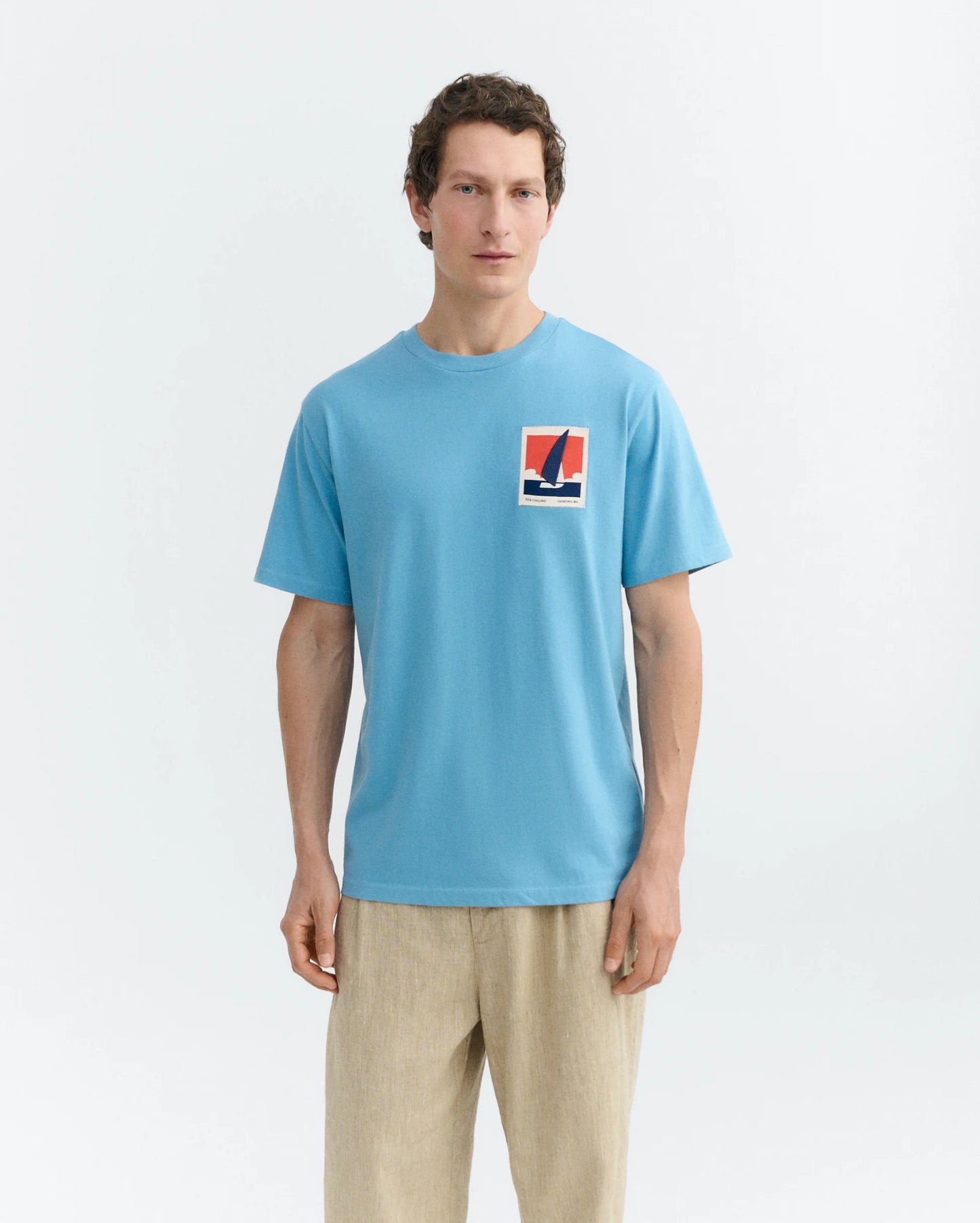 BLUE T-SHIRT PATCHED OPTIMIST ZACH - FRONT OF